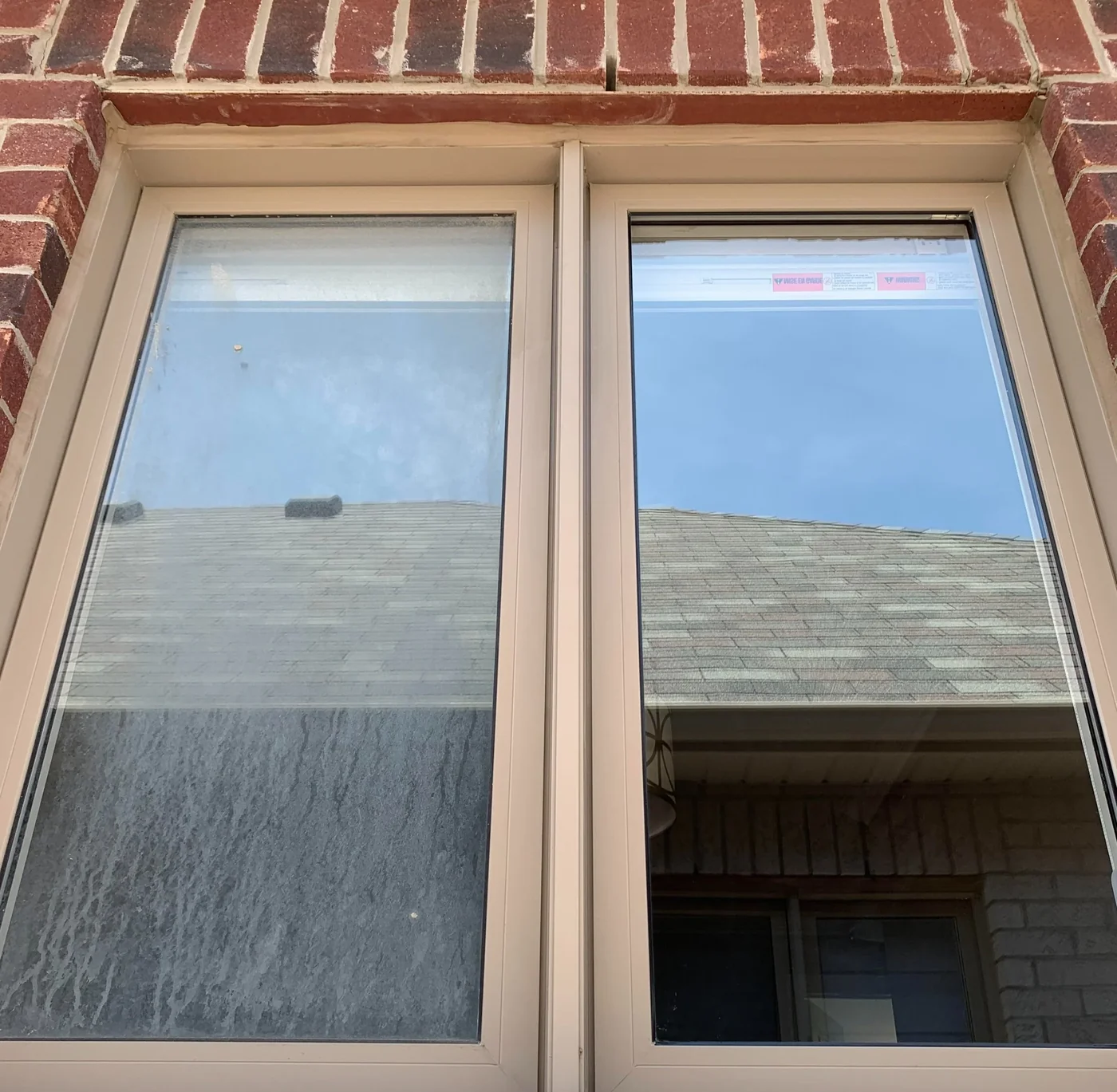 Two home windows side by side: the left still hazy with hard-water film, the right clean and clear after window cleaning